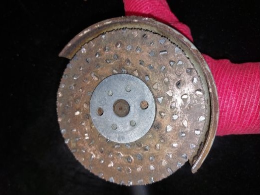 An Abrasive metal disc (tungsten carbide).